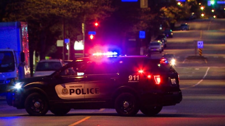 VPD police car sits in the middle of the road.