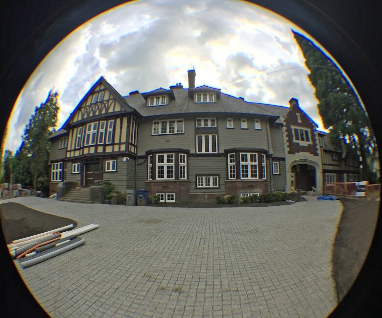 A fisheye view of a mansion with grey walls.