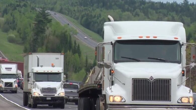 semi trucks driving on a highway