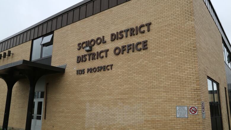 A beige brick building that says 