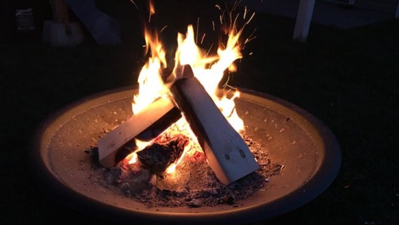 A fire burning in an outdoor fire pit.