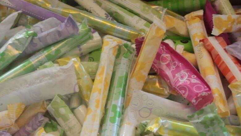 A close-up shot of colourfully-wrapped tampons