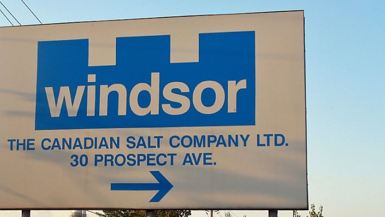 A blue and white sign saying Windsor Salt