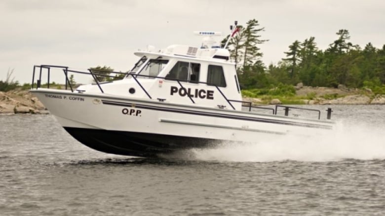 A white boat in the water with 