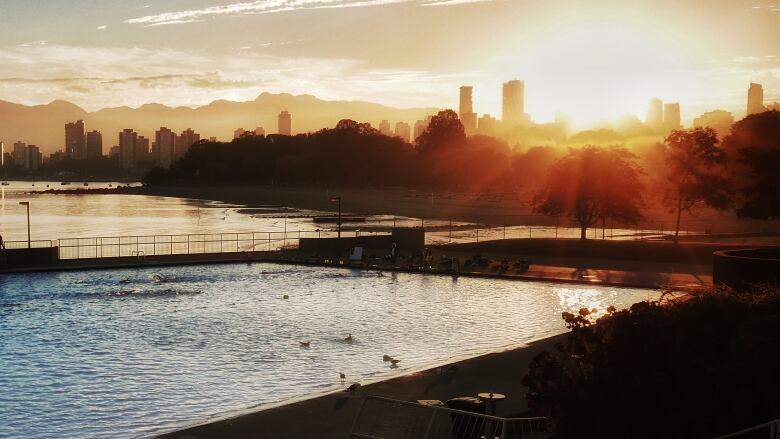 Early morning lane swimmers at Kitsilano pool enjoy a gorgeous sunrise.