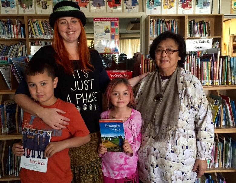 A mother, grandma, and two young boys.