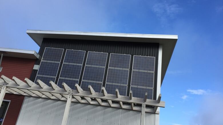 Solar panels on the second storey of a building.