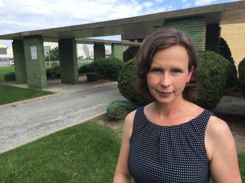 A woman in front of the CBC Windsor building