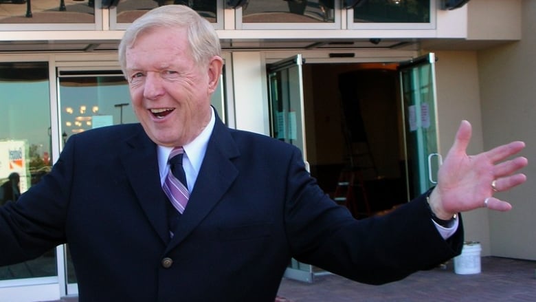 DJ Red Robinson poses for the camera outside.