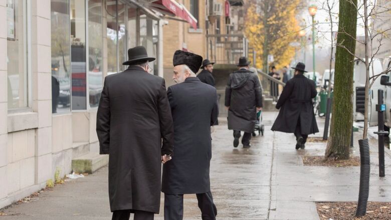 Hasidic Jews walk along Bernard Street in Outremont in Montreal. 