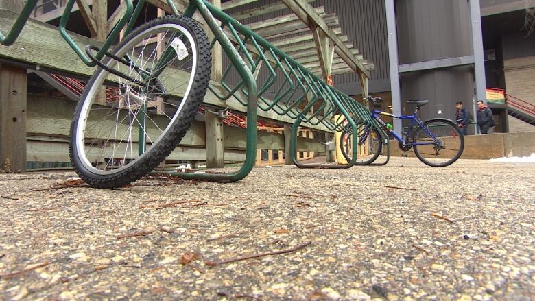 This picture shows a bike rack with bikes locked to it.