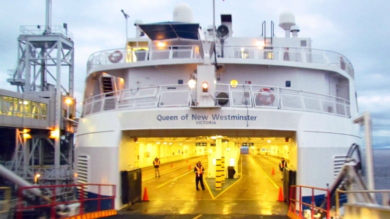 A B.C. Ferries vessel docked with its car decks visible.