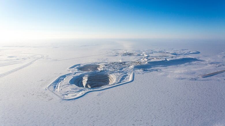 Aerial photo of an opening mining pit in the winter.