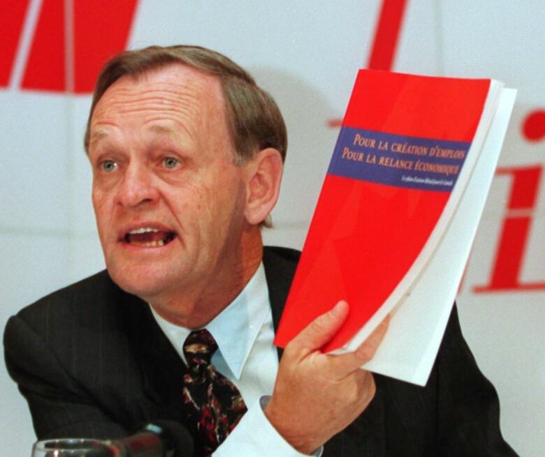 Jean Chretien brandishes the Liberal Red Book from 1993.