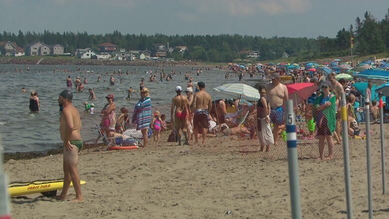 People standing around on Parlee Beach, a popular summer destination in Atlantic Canada. 