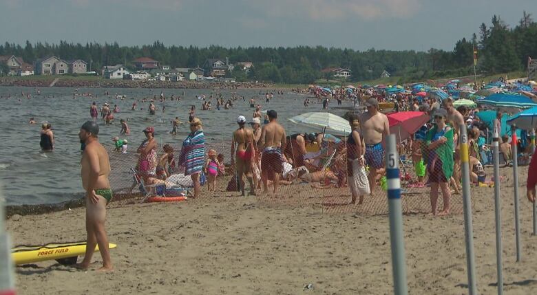 People standing around on Parlee Beach, a popular summer destination in Atlantic Canada. 