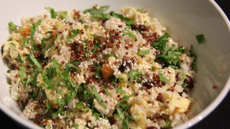 Bowl of quinoa, egg, green onions and sesame seeds