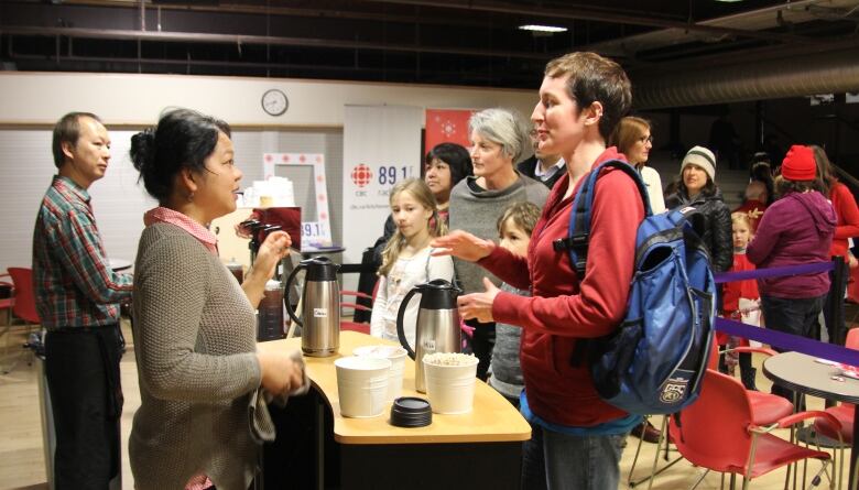 People talk to people serving coffee