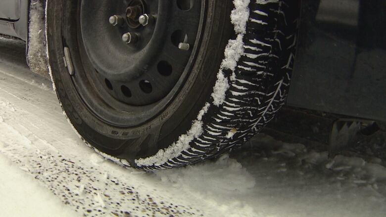 A winter tire on snowy terrain.