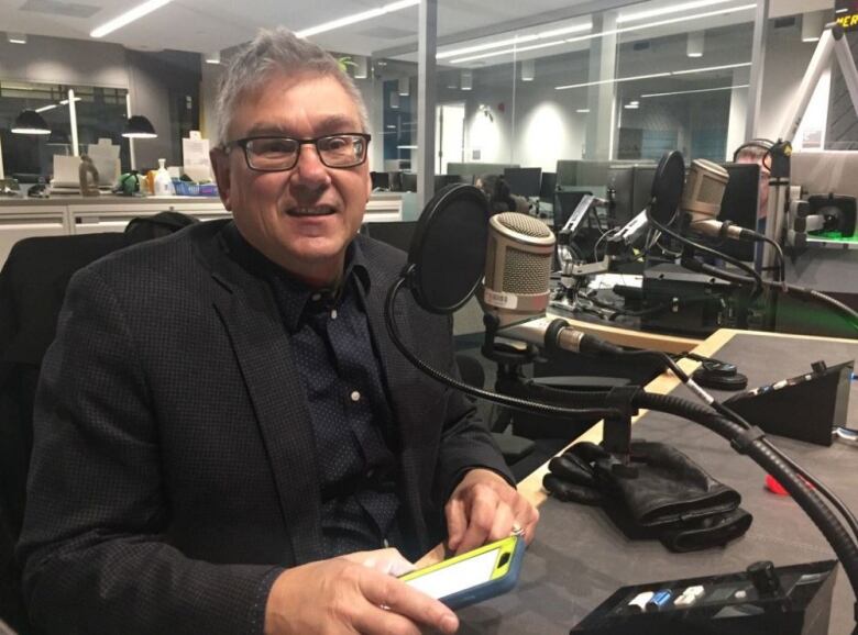 A man sitting in a studio.