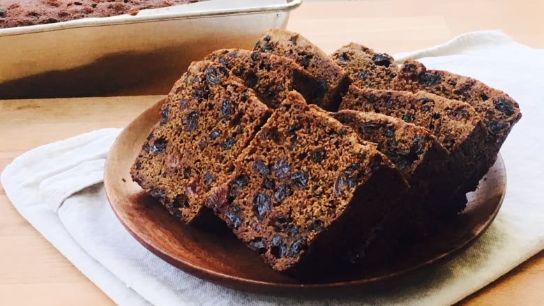 Slabs of brown cake are presented on a brown plate. 