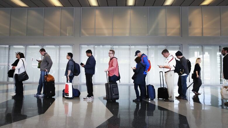 Passengers in line at an airport.