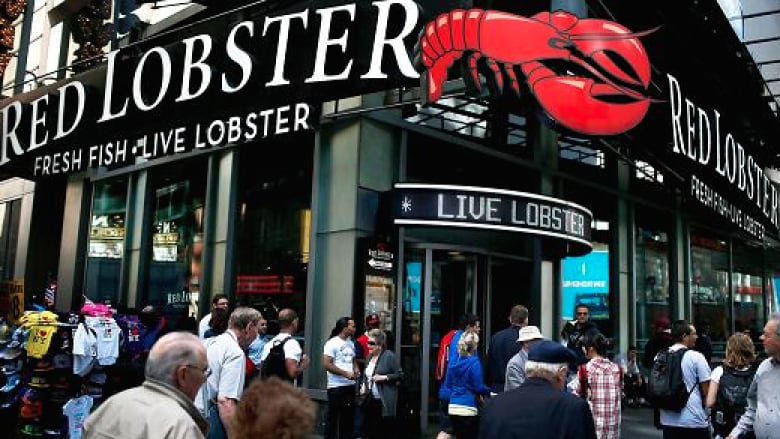 A Red Lobster restaurant is pictured with people walking by.