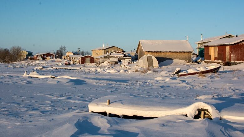 Snow covers boats and homes. 