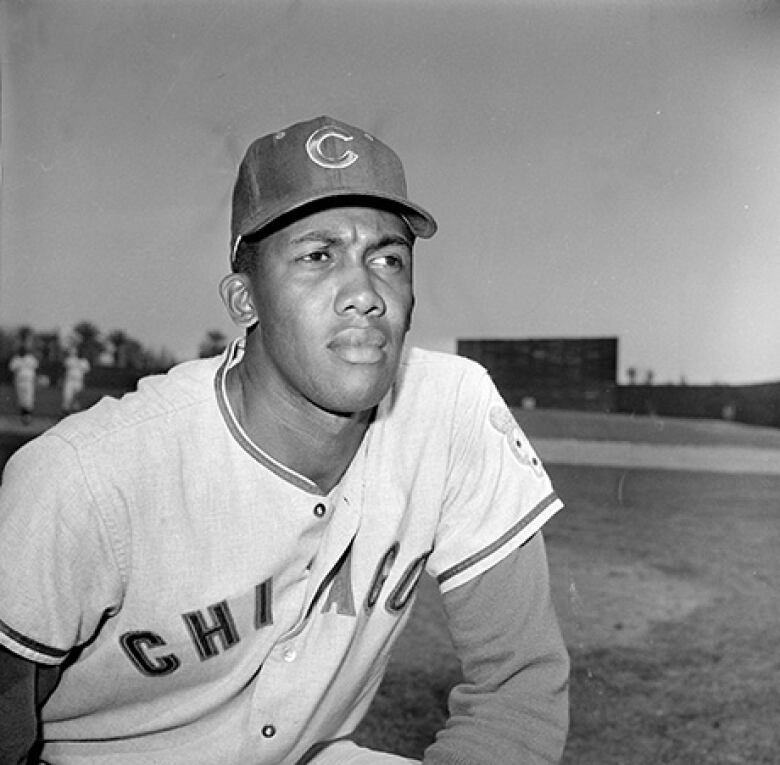 A black-and-white photo of a baseball player.