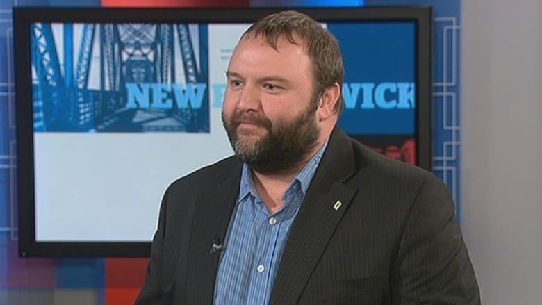 A person in a suit in the CBC TV studio.