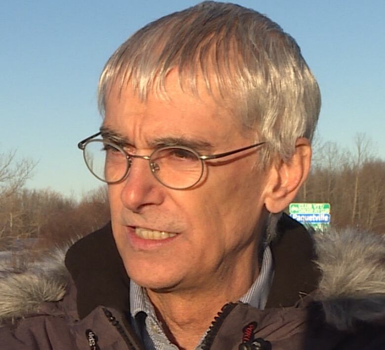 Portrait of Jacques Poirier in winter, snow in background