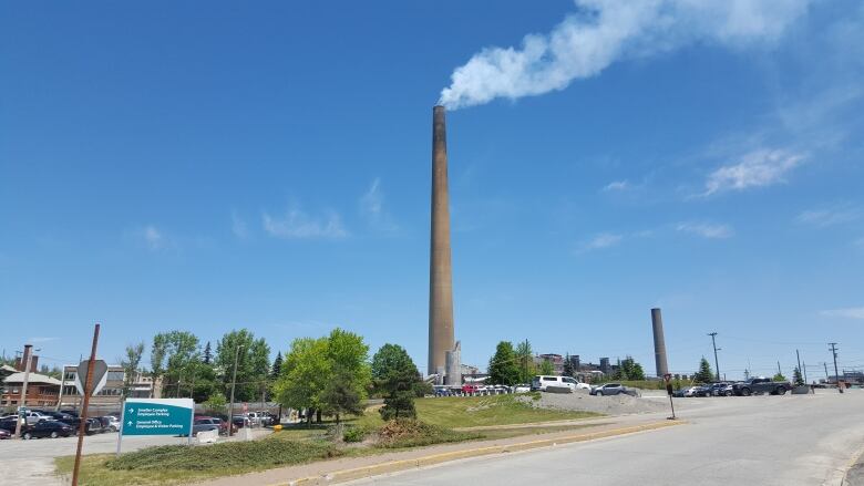 A large smokestack billowing smoke.