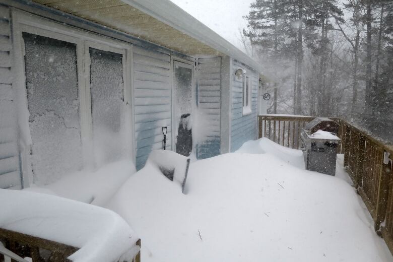 Blowing snow buries most of a deck and half a house as the storm blew through Nova Scotia.