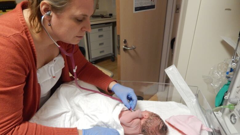 A midwife caring for a newborn baby.