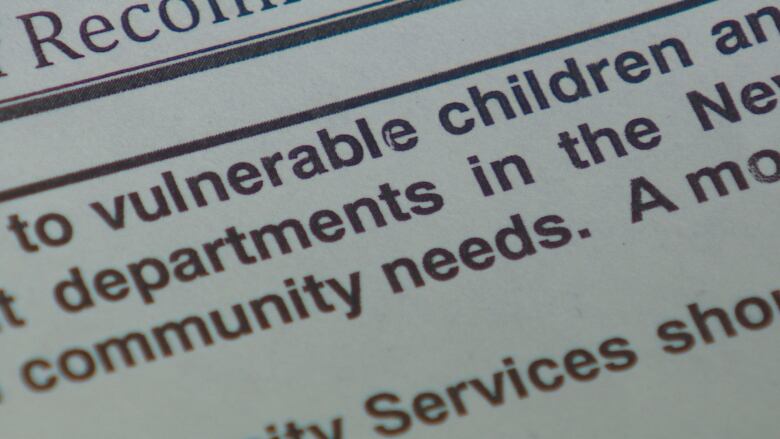 The words 'vulnerable children' are shown on a close-up of a report printed on paper.