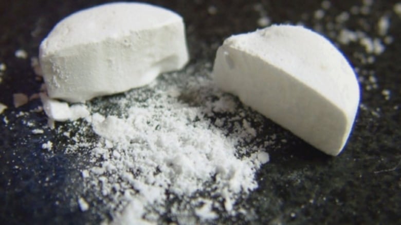 White fentanyl pills are partially crushed.