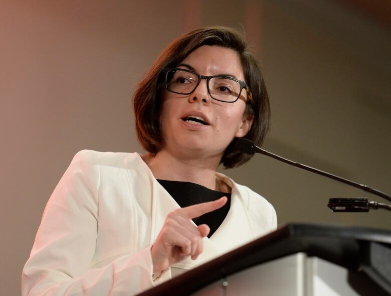 A woman speaks into a microphone.