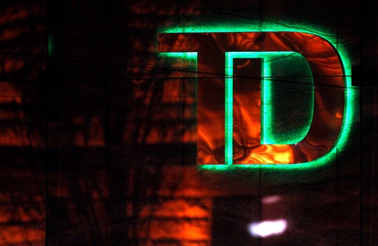 The TD bank logo glows with a green hue.