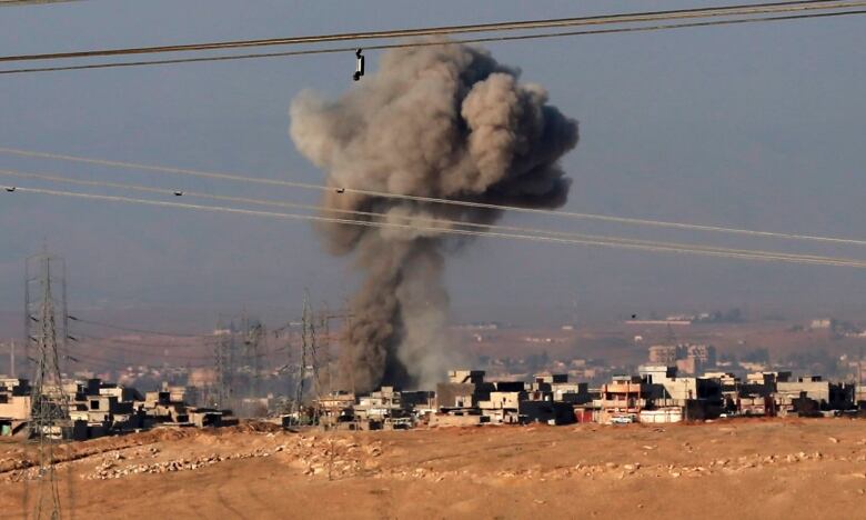 Smoke rises from a bomb strike.