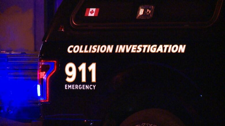 A police van with flashing lights that reads 'Collision Investigation'.