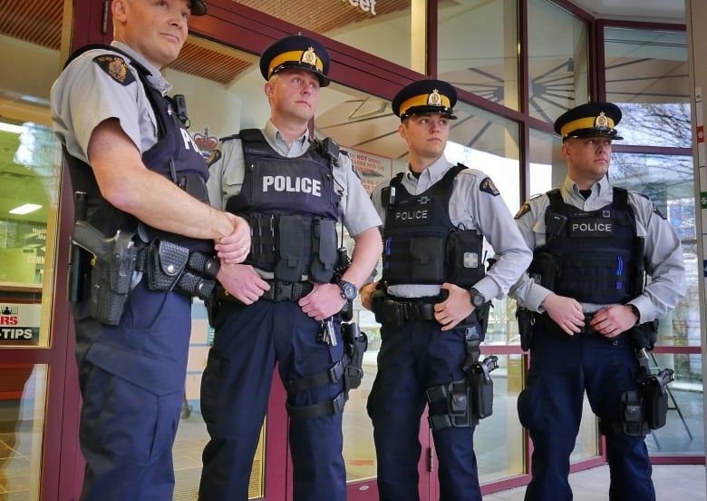 Members of the North Vancouver RCMP wear plain navy cargo pants, removing the traditional yellow stripe in protest.