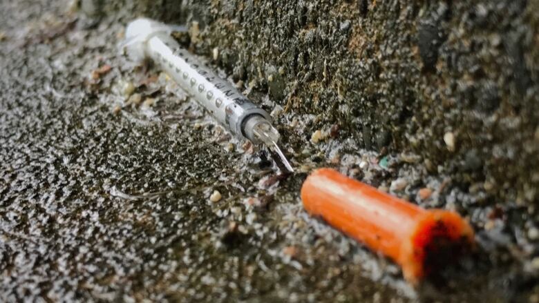 Close-up of a needle on the ground.