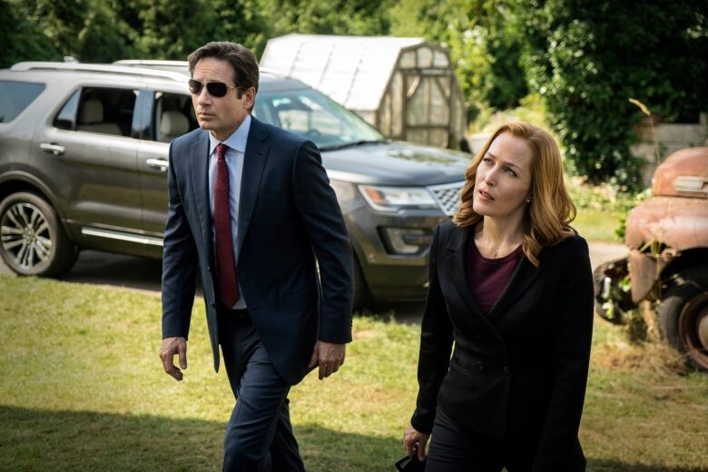 This photo provided by FOX shows, David Duchovny, left, as Fox Mulder and Gillian Anderson as Dana Scully in an episode of 