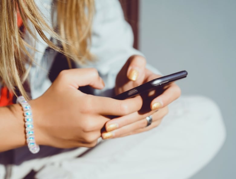 A stock image of a woman using a smartphone.