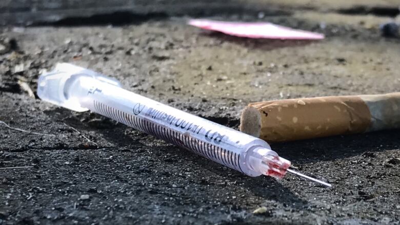 a needle on the ground, shown in a CBC stock image.