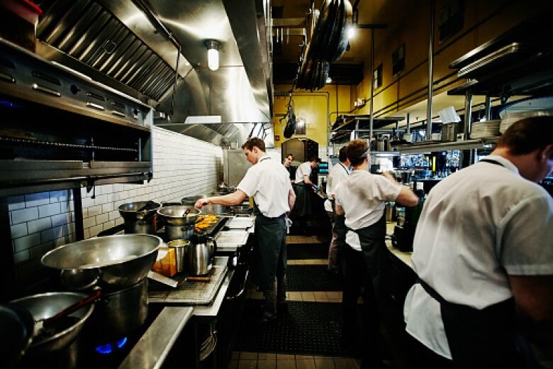 Chefs and cooks working in a kitchen.