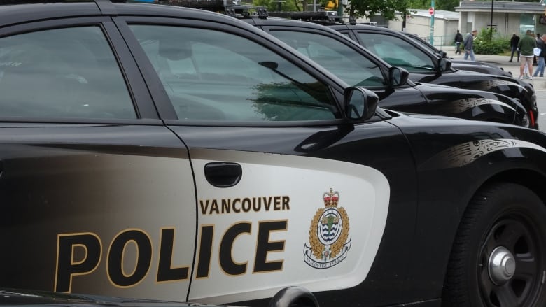 A black car with the Vancouver police logo and sign.