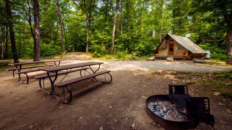 Two picnic tables and an all-season tent on a campsite at the Lac Philippe campground in Gatineau Park.