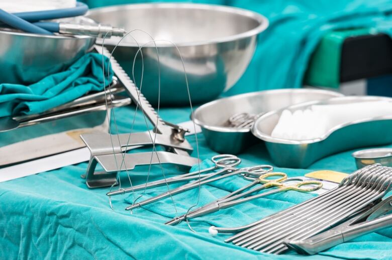 Surgery instruments laid on blue fabric