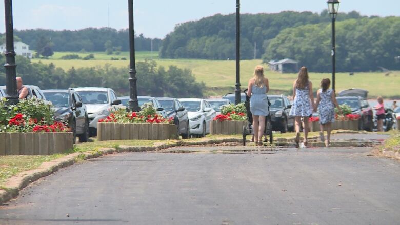 Pedestrians walk on a closed road.